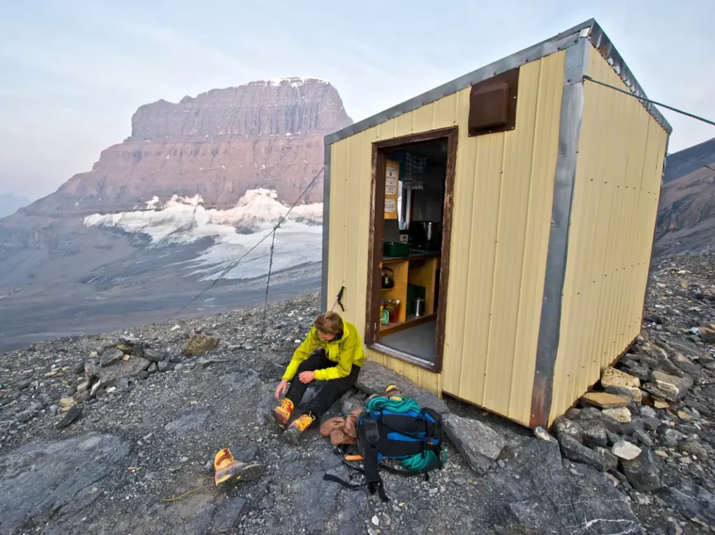 Climber in front of Mt Alberta Hut