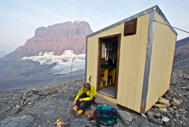 Climber in front of Mt Alberta Hut