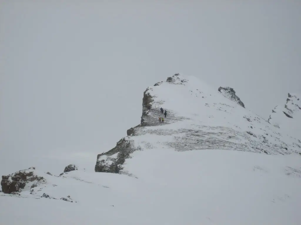 Ski mountaineers on summit ridge