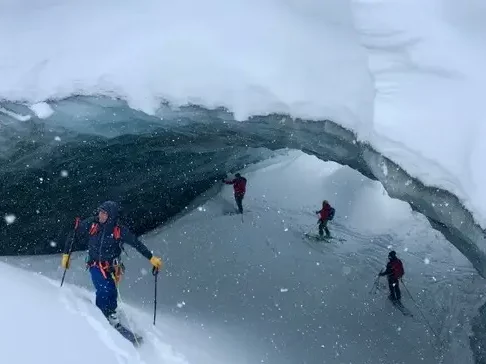 Ski mountaineers ice cave
