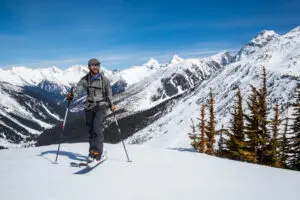 Man skiing uphill near the Asulkan Glacier in Roger's Pass area of Glacier National Park, Canada. Skier going uphill skinning, hiking