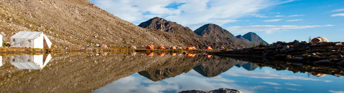 GMC camp by an alpine lake